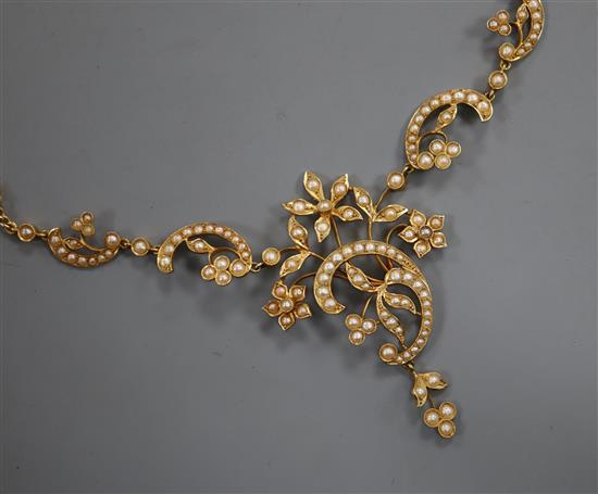 A yellow gold (tests as 18ct) and seed pearl openwork foliate necklace on fancy fine chain, approx. 39cm.